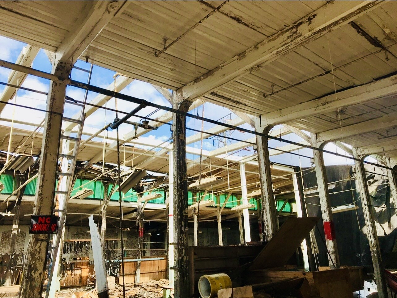 Interior industrial space during selective roof and building-component removal